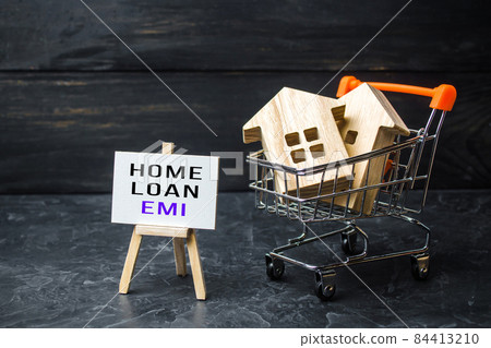 Houses in shopping cart and easel with home loan EMI. Equated Monthly Installment loan. Reducing debt with regular payments over loans period. Attractive interest rates, customized repayment options 84413210