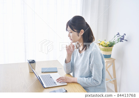 Female computer living room worried 84413768