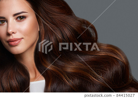 Beautiful brown-haired girl with a perfectly curls hair, and classic make-up. Beauty face and hair. Beautiful brown-haired girl with a perfectly curls hair, and classic make-up. Beauty face and hair. 84415027