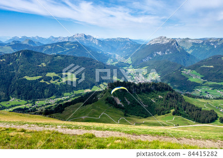 paragliding flight in the mountains. Le Grand-Bornand, France 84415282