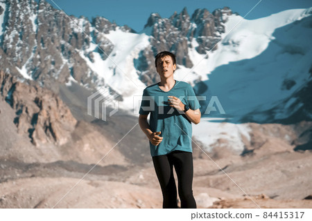 Man is running, training in the moruntains. 84415317