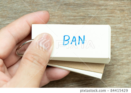 Man hold the flash card with handwriting word ban on wood background Man hold the flash card with handwriting word ban on wood background 84415429
