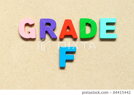 Color alphabet letter with word grade F on wood background 84415442