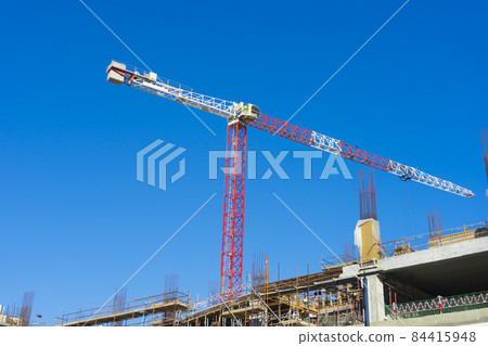 Crane and building construction site. Construction site with crane and building.  84415948