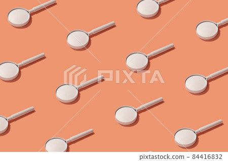 Pattern of magnifier on trending coral background for exploration and analysis of different data. 84416832