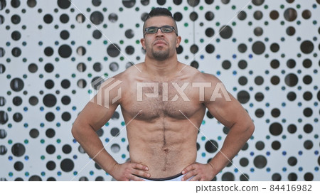 Muscular young man Arab posing against white background. 84416982