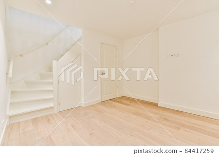 Luxurious bright room with parquet floor and staircase 84417259