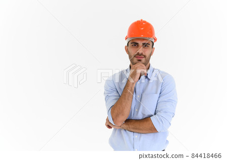 Portrait of young construction engineer wear orange hardhat, standing on white background with copy space. 84418466
