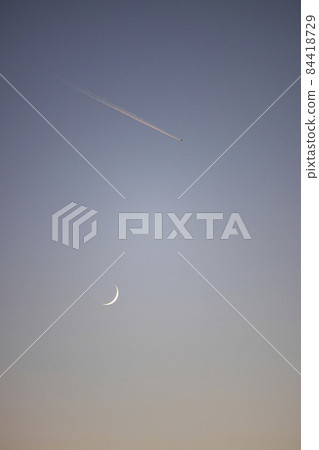 Contrails and crescents at dusk 84418729