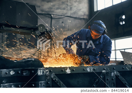 Fitter working with special machine for welding metal.  84419014