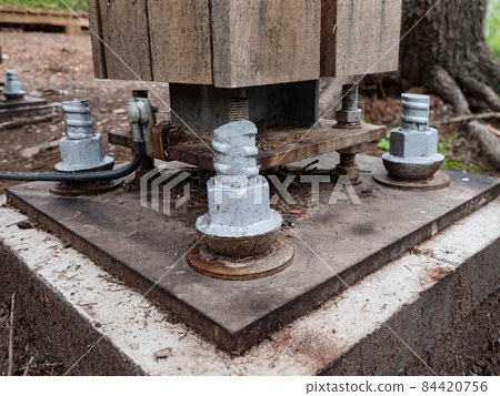 Bridging joint of girder bridge with concrete base in ground. 84420756