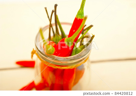 red chili peppers on a glass jar 84420812