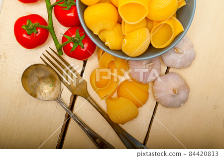 Italian snail lumaconi pasta with tomatoes 84420813