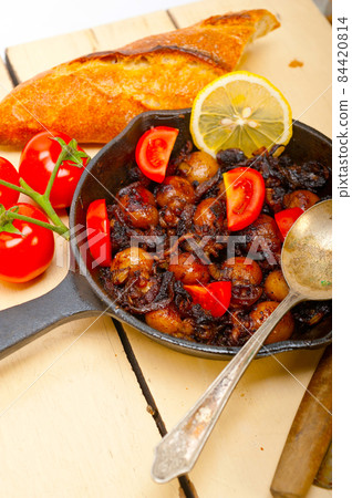 Baby cuttle fish roasted on iron skillet 84420814