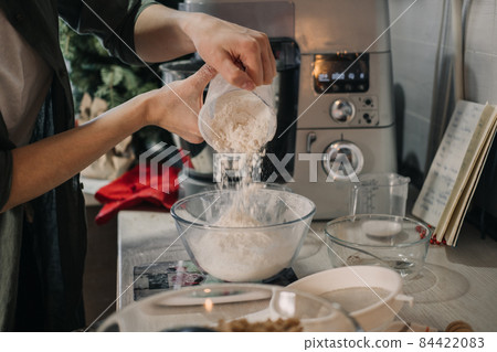Cooking dough for gingerbread. Products and ingredients on kitchen table ready for making Christmas gingerbread. Making Christmas gingerbread at home. 84422083
