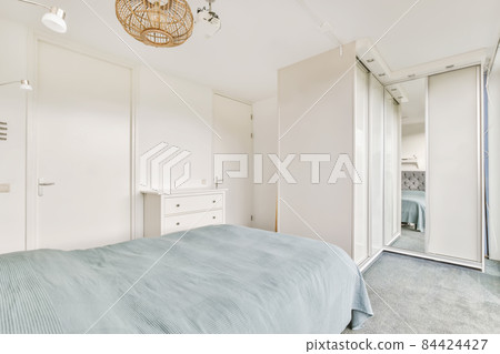 Comfortable bed with duvet in minimalist style bedroom in modern apartment Comfortable bed with duvet in minimalist style bedroom in modern apartment 84424427