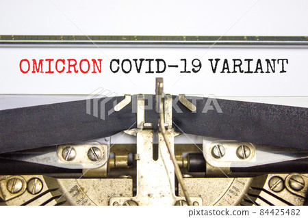Covid-19 new omicron virus variant symbol. Concept words Omicron covid-19 variant typed on retro typewriter. Medical and COVID-19 pandemic new omicron variant strain mutation concept. 84425482