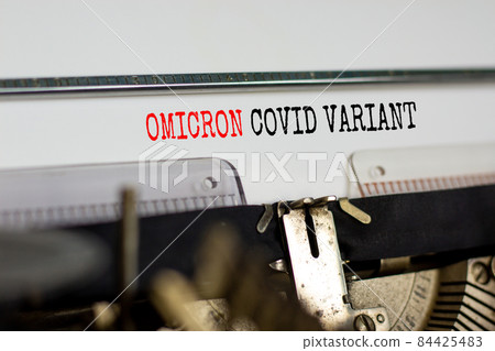 Covid-19 new omicron virus variant symbol. Concept words Omicron covid variant typed on retro typewriter. Medical and COVID-19 pandemic new omicron variant strain mutation concept. 84425483