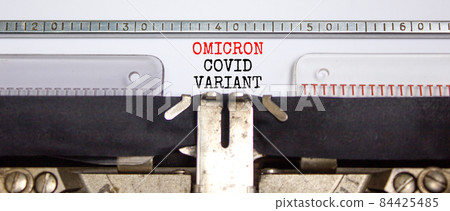 Covid-19 new omicron virus variant symbol. Concept words Omicron covid variant typed on retro typewriter. Medical and COVID-19 pandemic new omicron variant strain mutation concept. 84425485