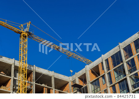Large construction site with busy tower cranes at high-rise building Large construction site with busy tower cranes at high-rise building 84425731