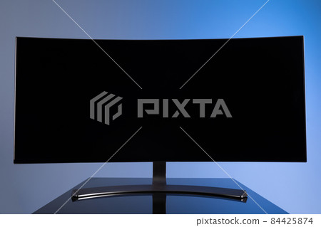 large widescreen monitor with copy-space on gray-blue background large widescreen monitor with copy-space on gray-blue background 84425874