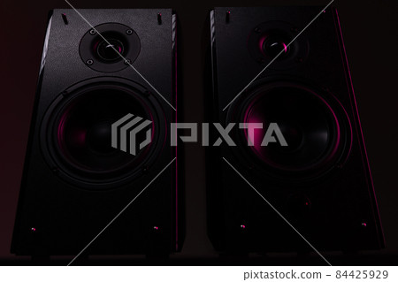 photograph of a strong speaker on a black background with red-purple illumination, bottom view 84425929