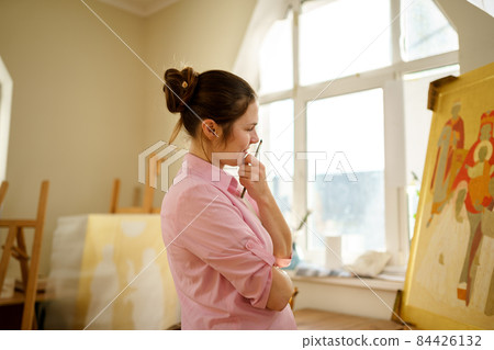 Art, creativity, hobby and creative occupation concept. Bringing creativity to life. Woman painting in art studio. Attractive female artist painting in workshop. Woman hobby, activity, profession 84426132