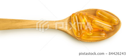 Fish oil capsules in wooden spoon isolated on white background with clipping path and full depth of field. Top view. Flat lay 84426243