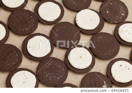 chocolate cookies with creamy cream filling chocolate cookies with creamy cream filling 84426455