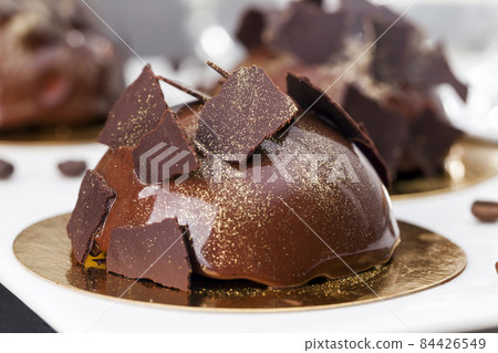 delicious chocolate cake covered with milk chocolate 84426549
