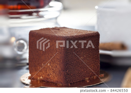 delicious chocolate cake with a cube shape on the table delicious chocolate cake with a cube shape on the table 84426550