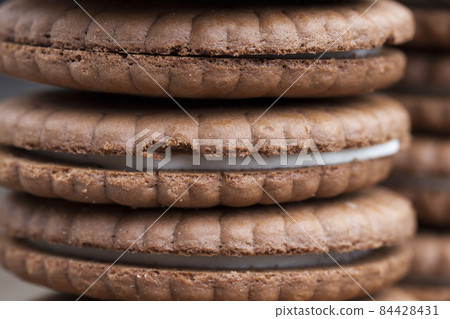 sweet cookies with milk filling 84428431