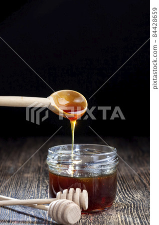 current thick and delicious sweet honey, close up current thick and delicious sweet honey, close up 84428659