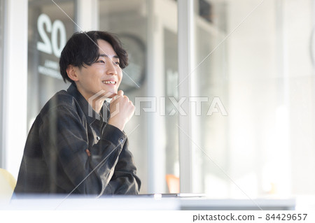 Laptop and refreshing young man 84429657