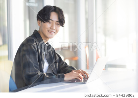 Laptop and refreshing young man Laptop and refreshing young man 84429802