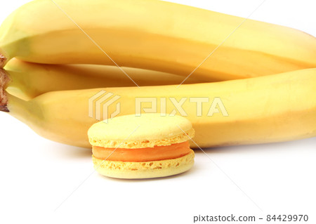 banana and macaroon isolated on white background banana and macaroon isolated on white background 84429970