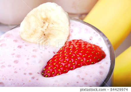 banana and strawberry smoothie on white background banana and strawberry smoothie on white background 84429974