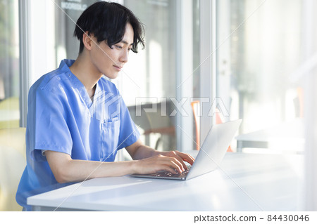 Laptop and refreshing young man 84430046