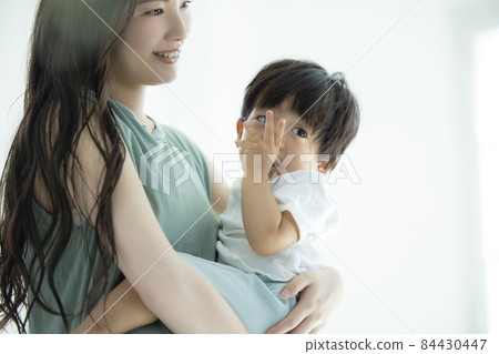 Mom hugging a 1 year old boy 84430447