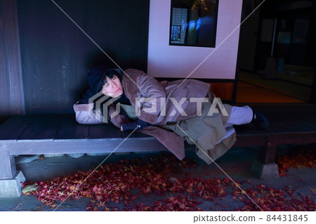 A woman lying on the porch of a private house while traveling A woman lying on the porch of a private house while traveling 84431845