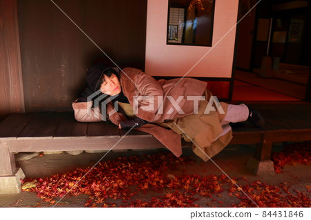 A woman lying on the porch of a private house while traveling A woman lying on the porch of a private house while traveling 84431846