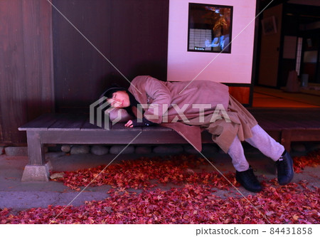 A woman lying on the porch of a private house while traveling A woman lying on the porch of a private house while traveling 84431858