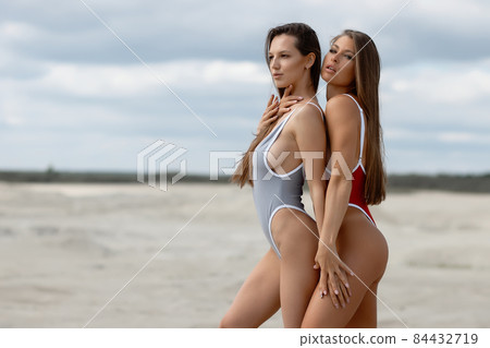 Sexy women in swimsuits on beach Sexy women in swimsuits on beach 84432719