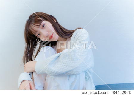 Model woman staring at us while sitting Model woman staring at us while sitting 84432968