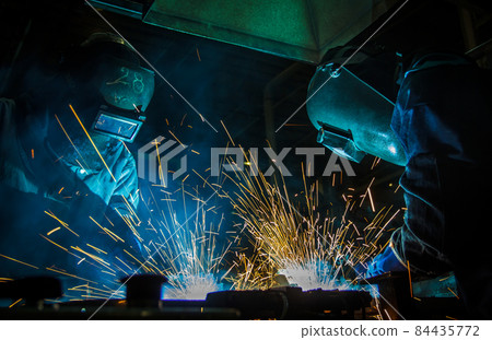 worker with protective mask welding metal 84435772