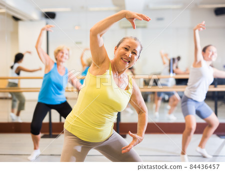Portrait of a positive European woman enjoying energetic dancing Portrait of a positive European woman enjoying energetic dancing 84436457