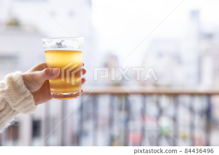 Female in a knit with a glass of beer Female in a knit with a glass of beer 84436496