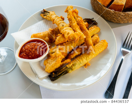 Delicious breaded calsot in tempura with the sauce Romesco 84436537