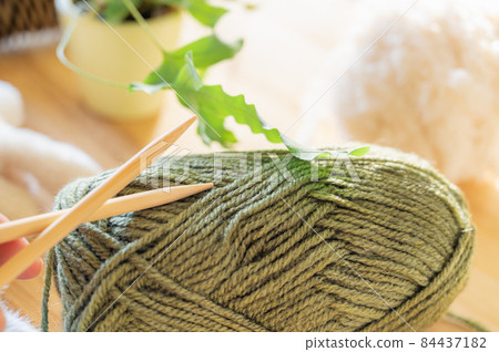 Yarn and knitting stick 84437182