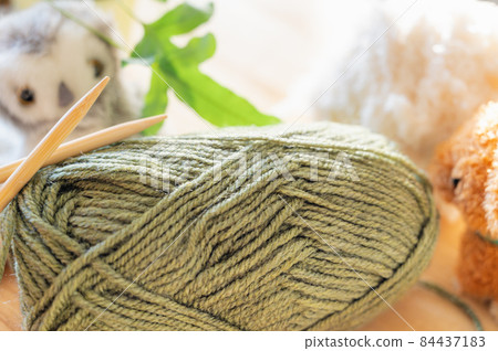 Yarn and knitting stick 84437183